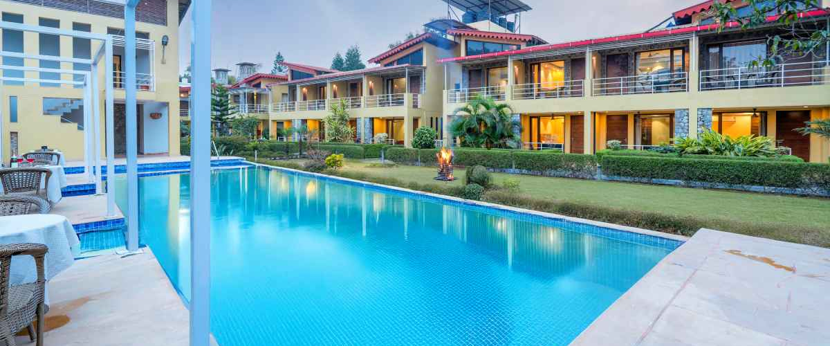 Swimming pool surrounded by jungle at Vasavana Resort
